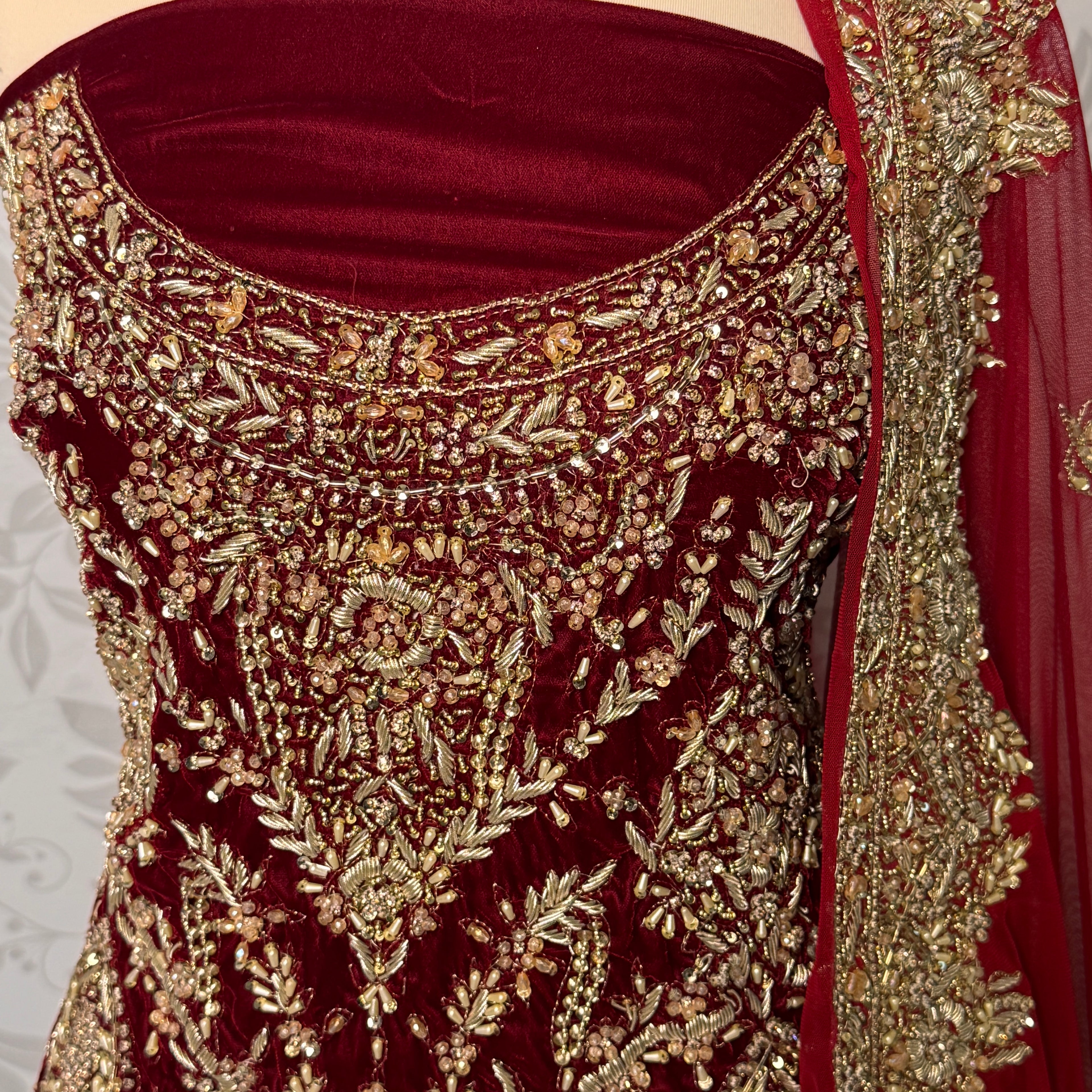 Bridal lehenga Pakistani BL032 shirt close up – kora jewelry hand work detail on deep anari red velvet fabric
