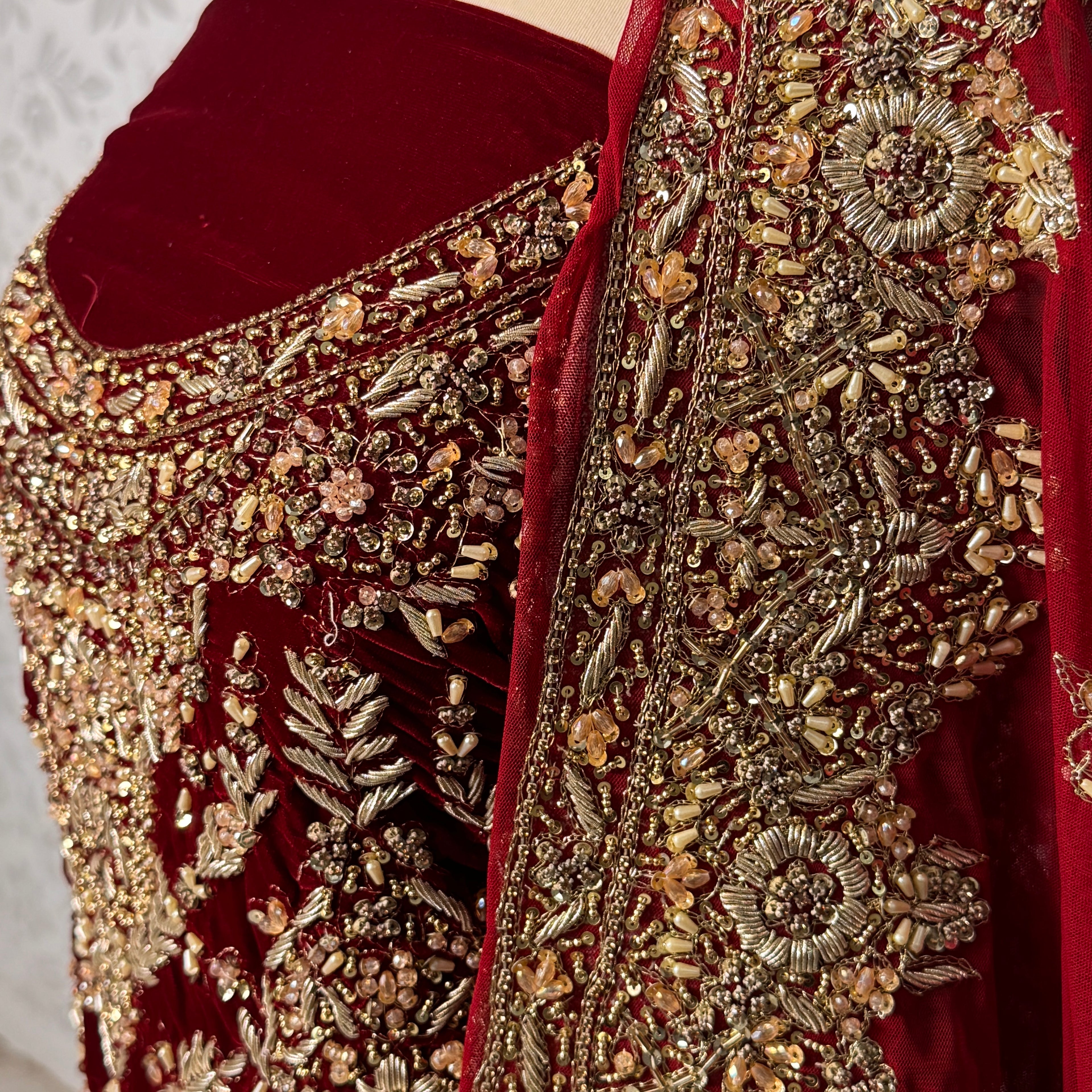 Bridal lehenga Pakistani BL032 shirt close up – kora jewelry hand work detail on deep anari red velvet fabric
