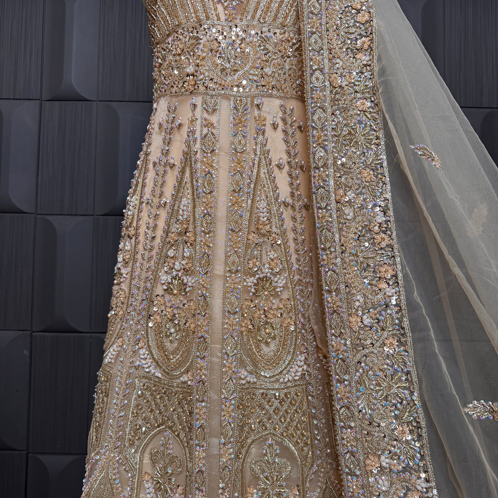 Bridal maxi for nikkah BM021 embroidery close up – dabka and jewelry hand work detail on skin gold net fabric
