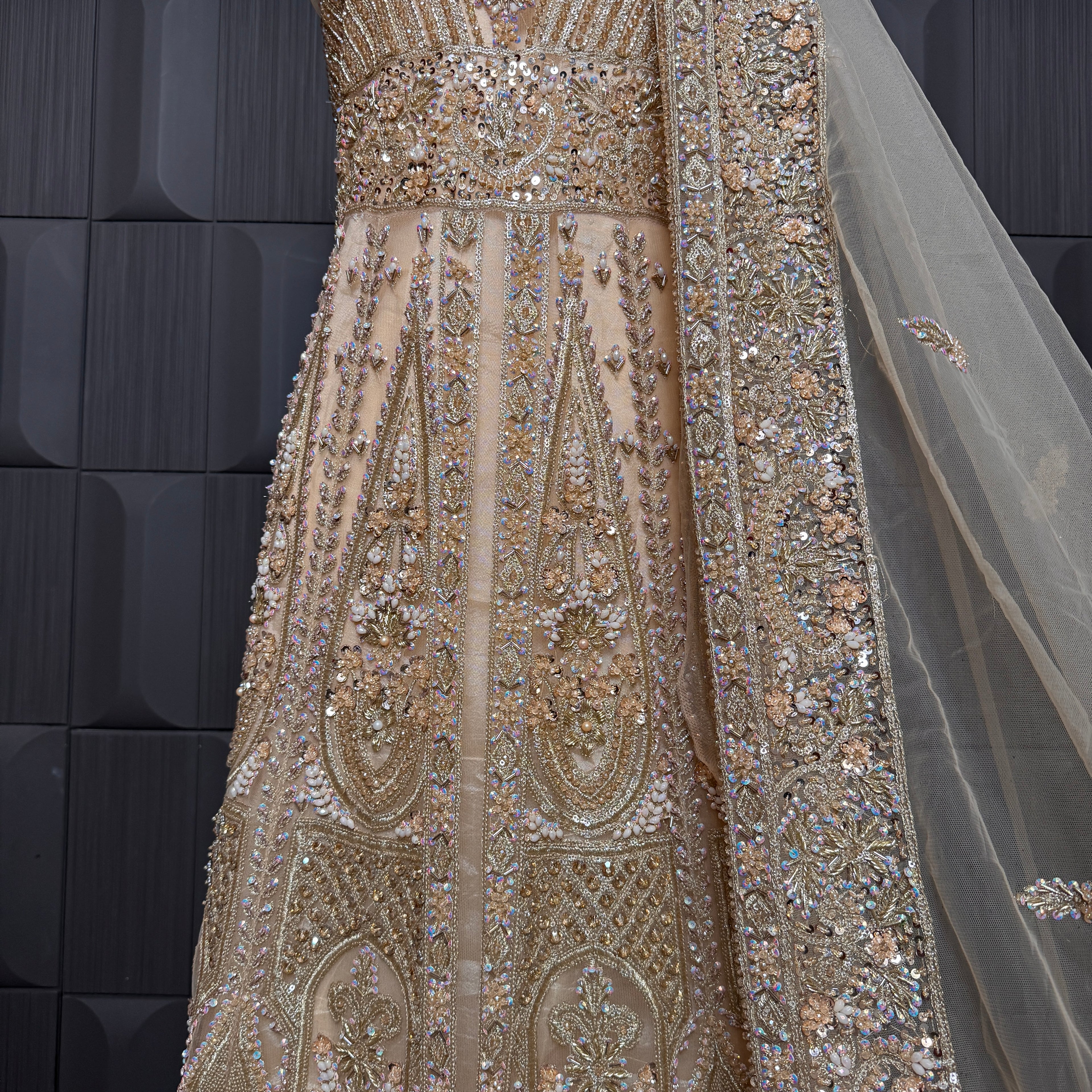 Bridal maxi for nikkah BM021 embroidery close up – dabka and jewelry hand work detail on skin gold net fabric
