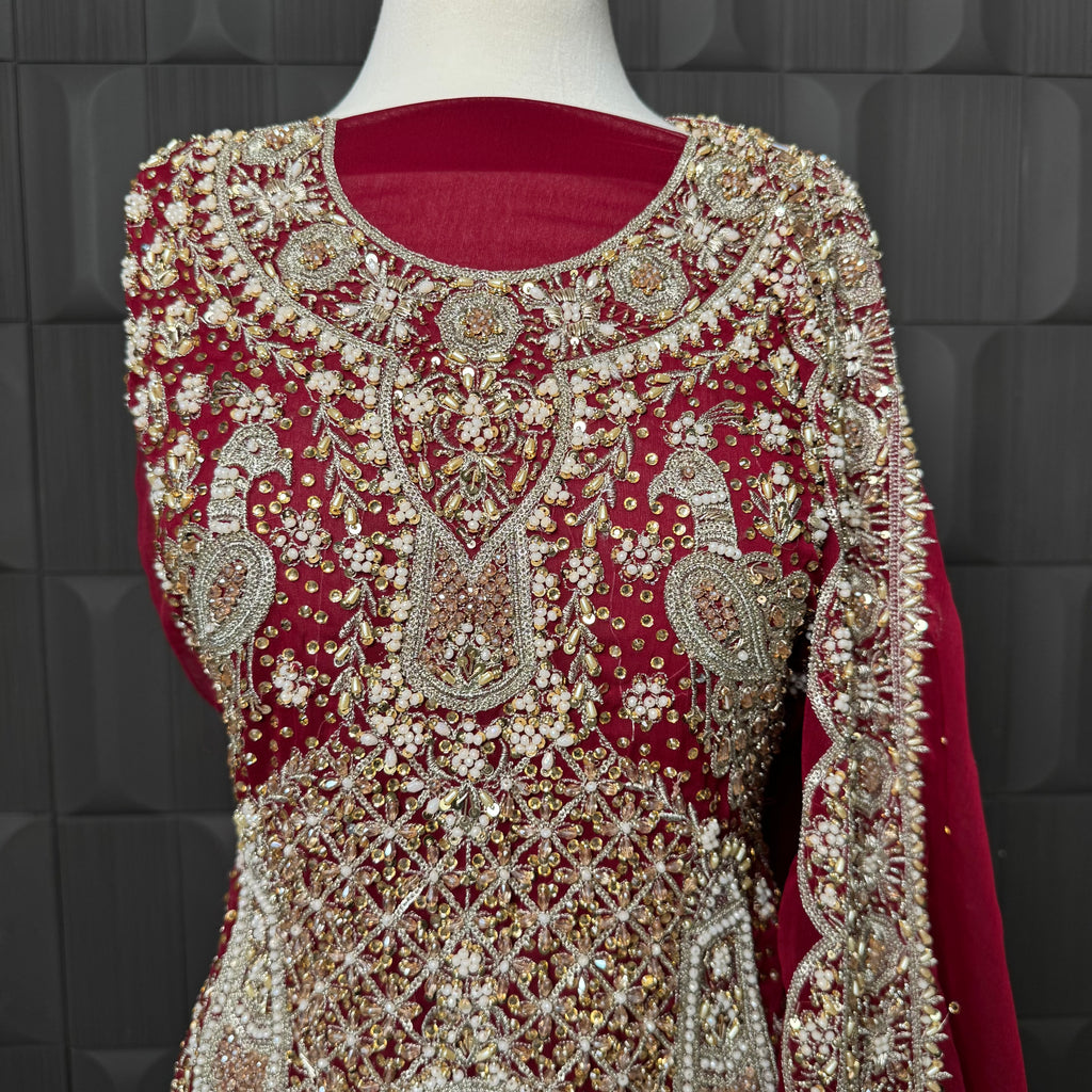 Wedding lehenga hand work close-up showing kora dabka jewelry material embroidery on red chiffon fabric