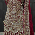 Wedding lehenga hand work close-up showing kora dabka jewelry material embroidery on red chiffon fabric