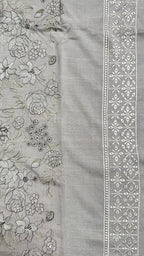 A close-up of a light gray fabric panel with floral embroidery on one side and a decorative embroidered border on the other.