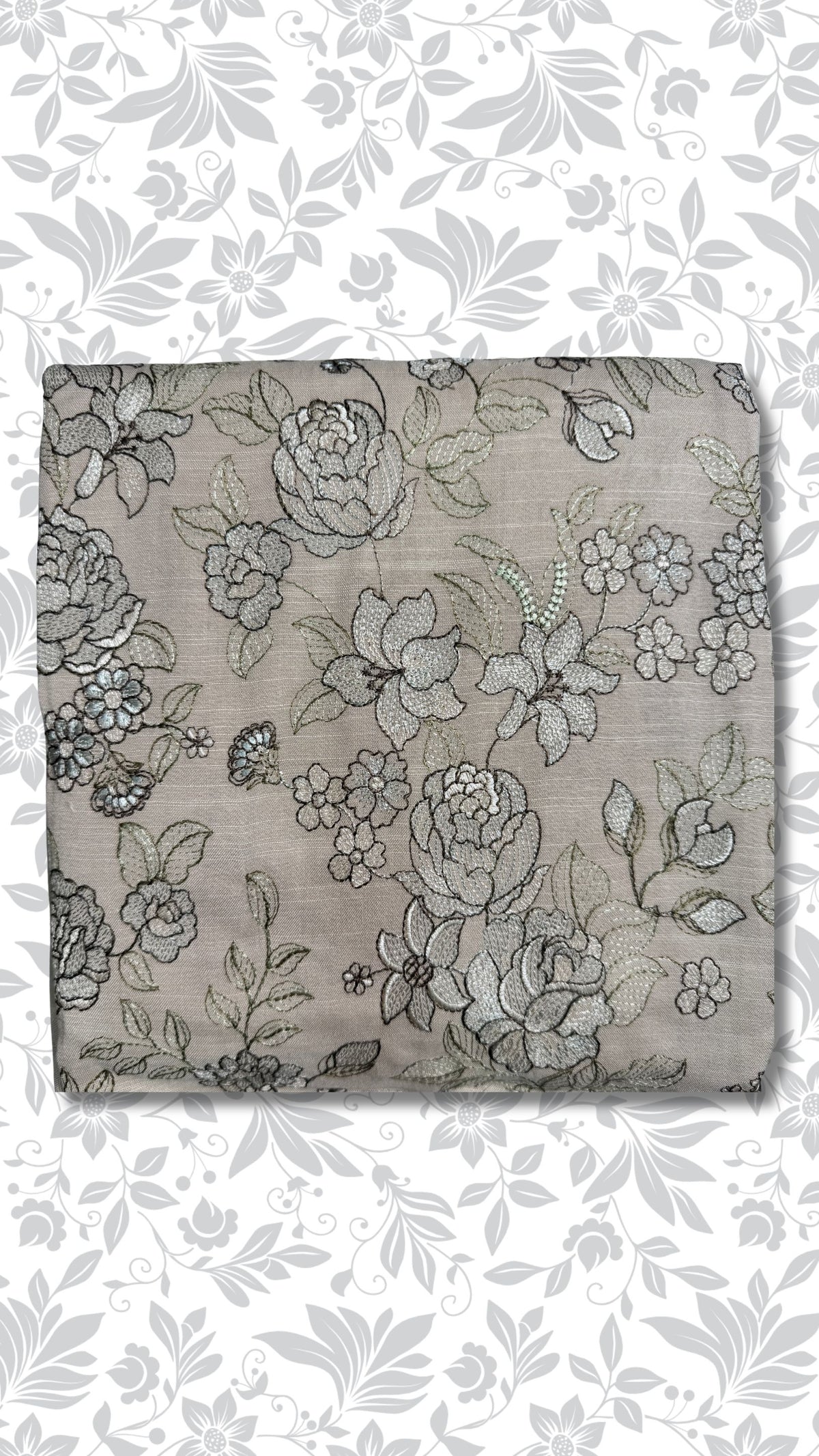 A folded piece of taupe fabric featuring an intricate black and gray floral embroidery pattern, presented against a white background with a matching gray floral watermark overlay.