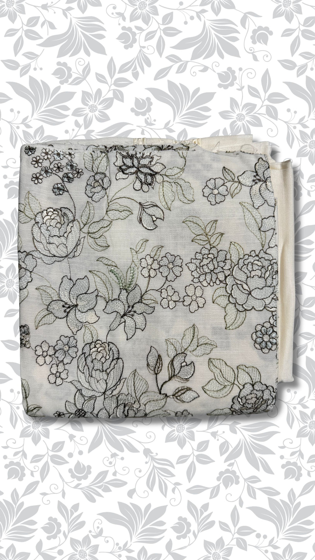 A folded piece of light gray fabric with a black floral line-art pattern, displayed against a white background with a matching gray floral watermark pattern.