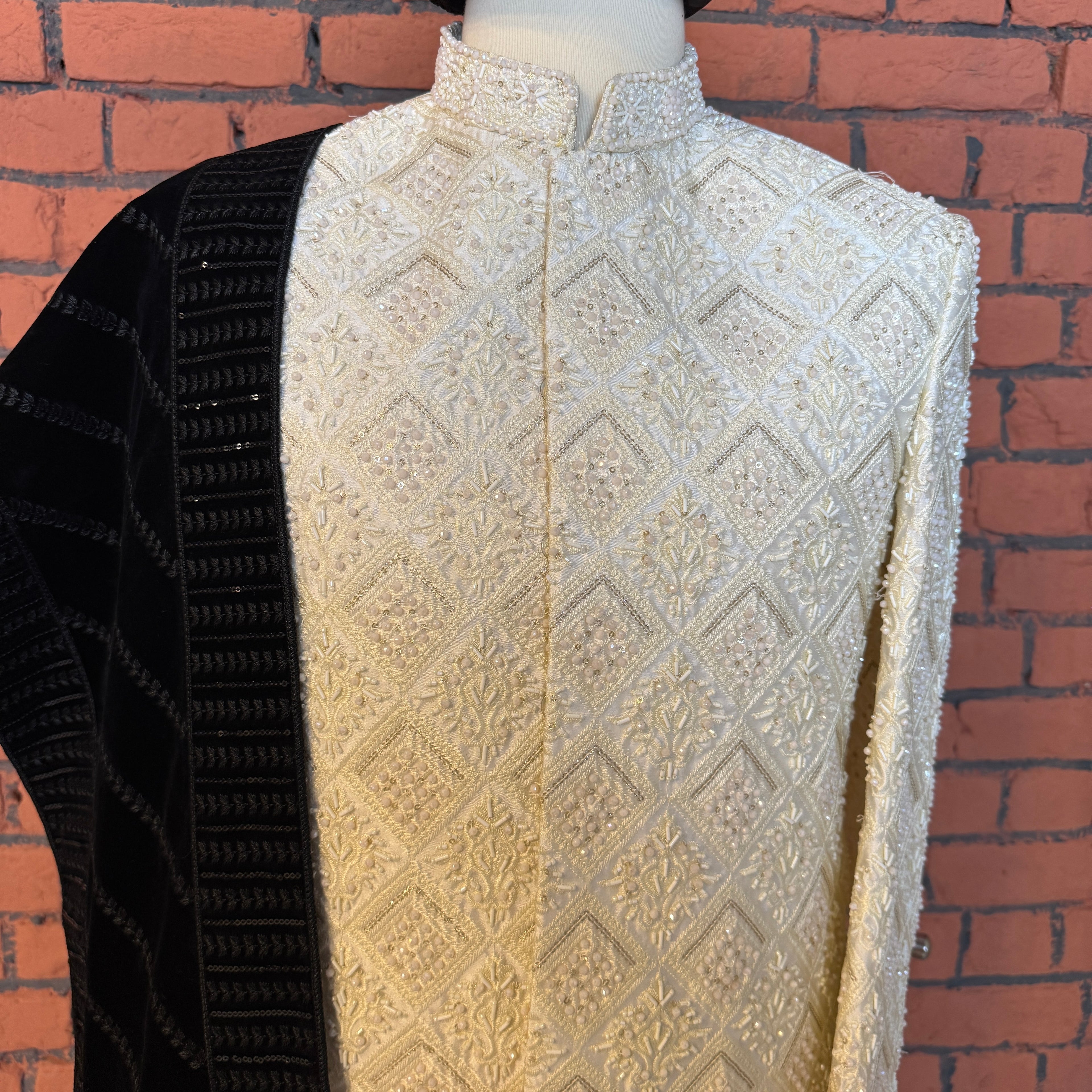 sherwani for groom off white shirt close-up with cutdana and crystal work

