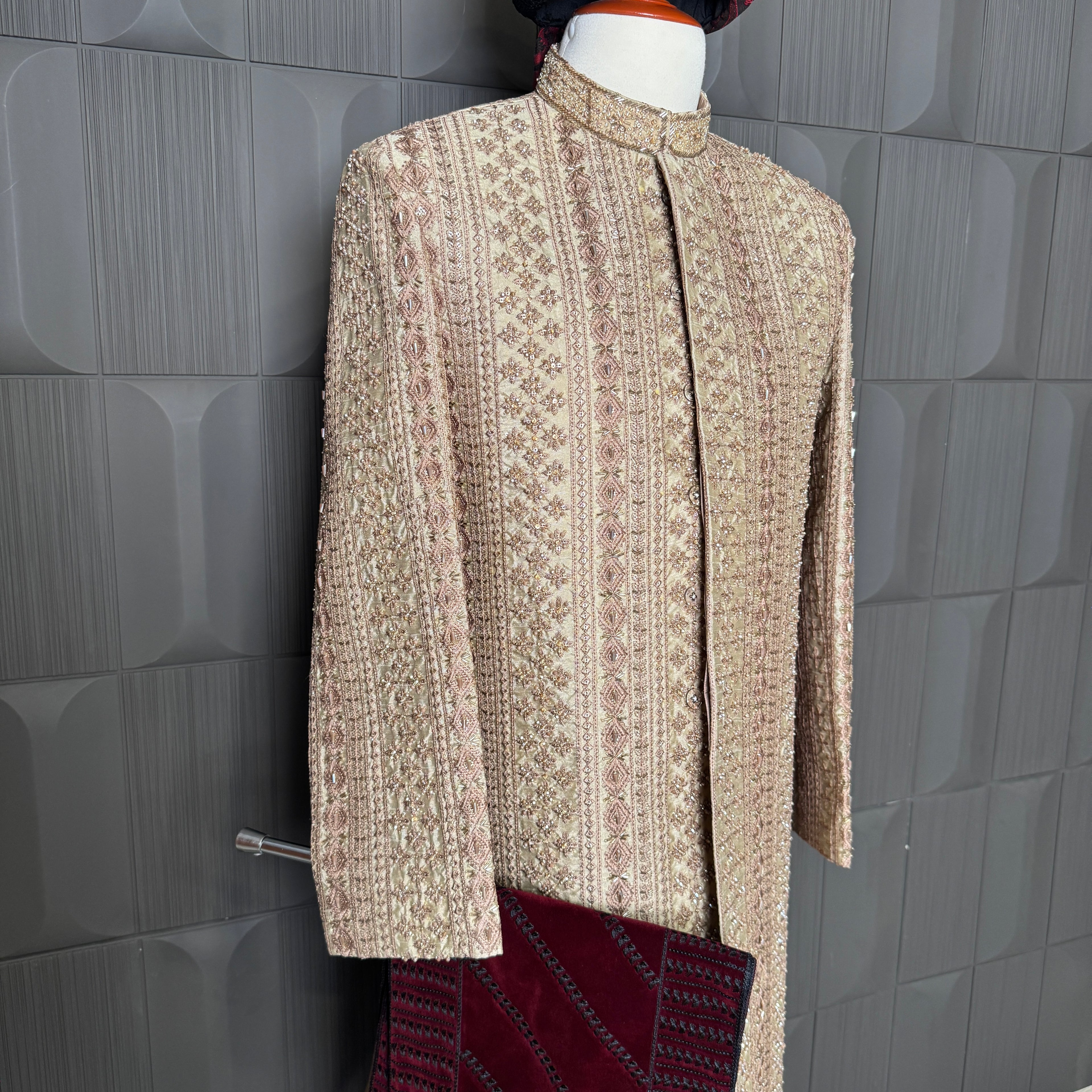 sherwani for groom skin gold shirt close-up with cutdana embroidery machine work
