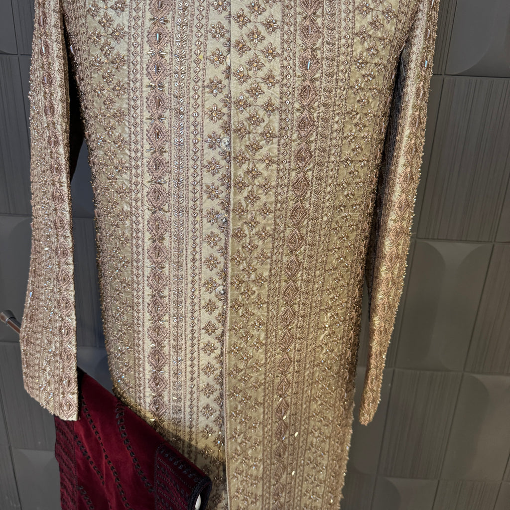 sherwani for men skin gold fabric and embroidery texture close-up
