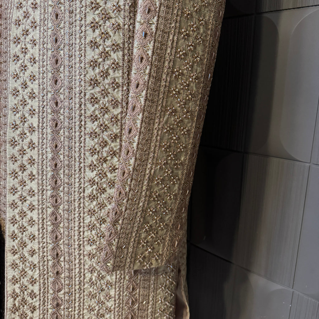 sherwani for men skin gold fabric and embroidery texture close-up
