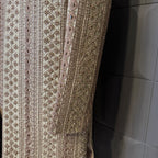 sherwani for men skin gold fabric and embroidery texture close-up
