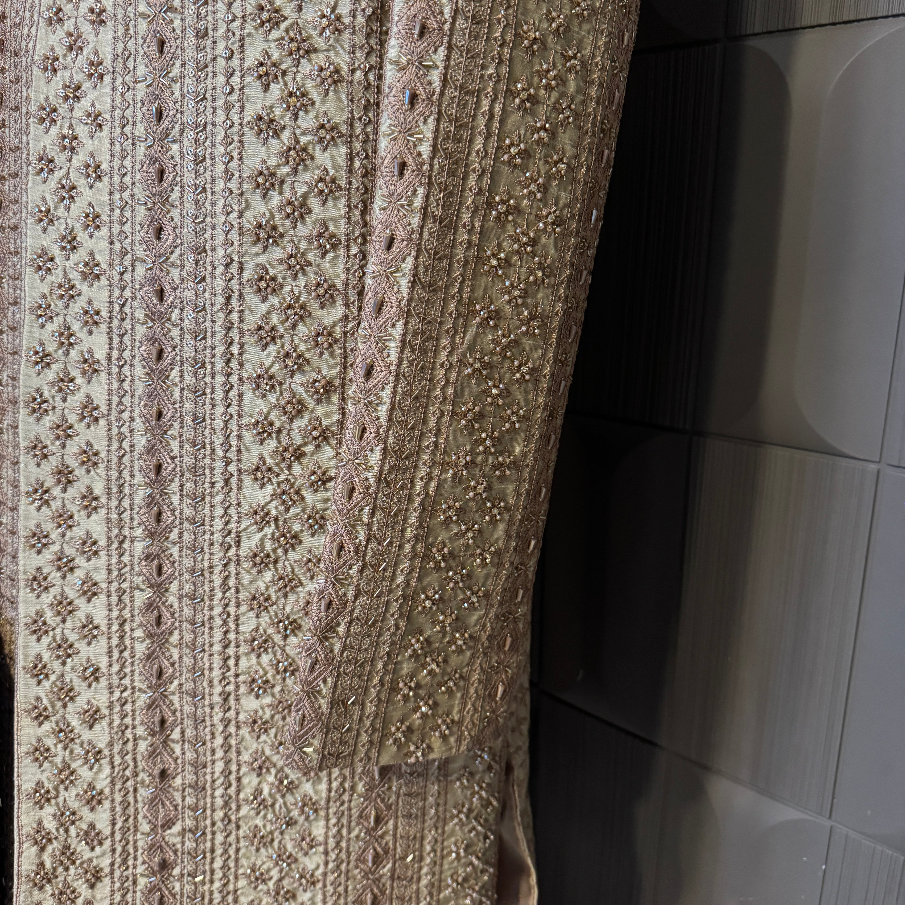 sherwani for men skin gold fabric and embroidery texture close-up
