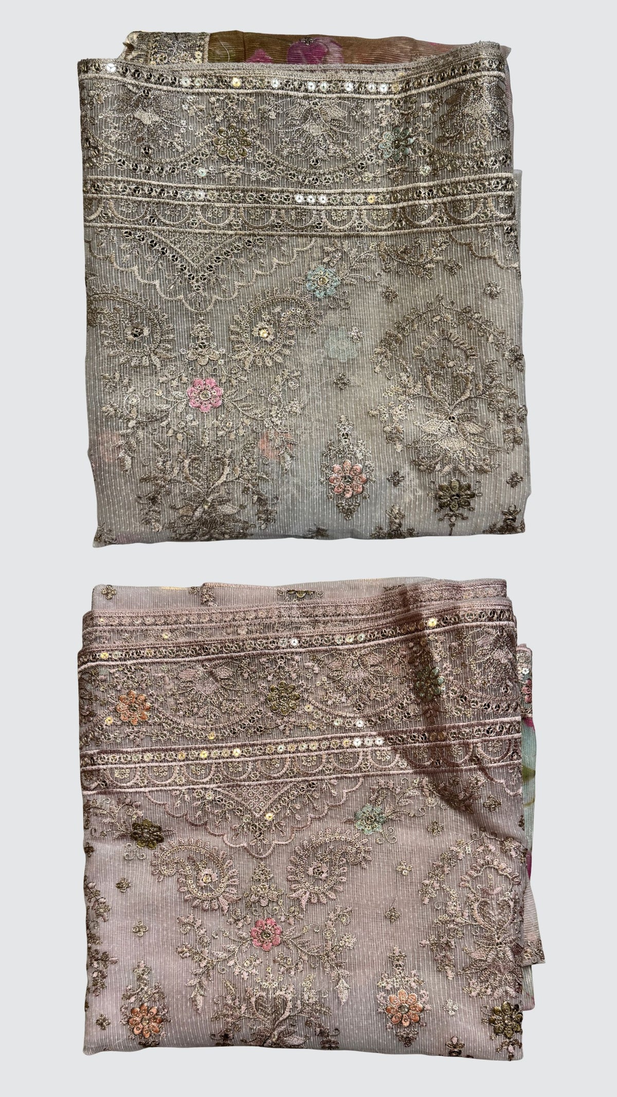 Two folded embroidered fabric pieces shown vertically on a light gray background. The top piece is a muted taupe-beige with silver mirror work and pastel floral motifs.