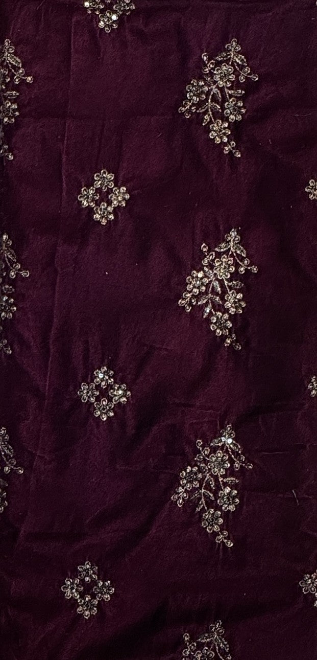 Deep maroon velvet fabric with silver and white floral embroidery and beadwork.
